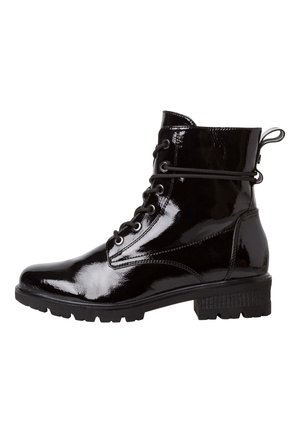 Bottine en cuir verni noir brillant avec lacets à l’avant, languette au talon, petit talon bloc et semelle robuste.