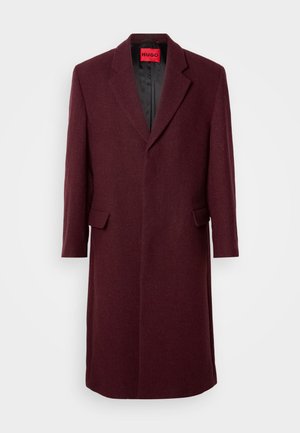 Burgundy tailored overcoat with a notched collar, side pockets, and a smooth interior lining. Wool texture with a structured silhouette.