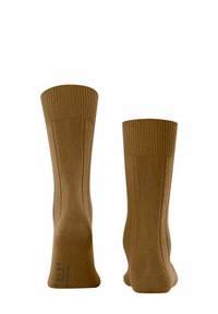 Calze in maglia marroni con polsini a coste e una texture liscia. Presentano un pannello semi-trasparente sui lati, che migliora la traspirabilità.