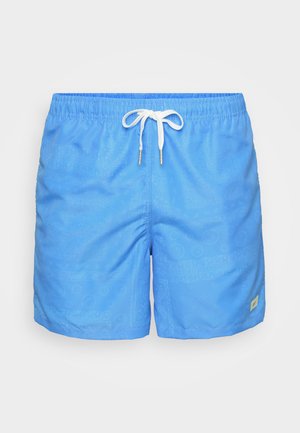 Light blue swim shorts made of quick-drying fabric. Features a drawstring waist and subtle tonal patterns. Side pockets included.