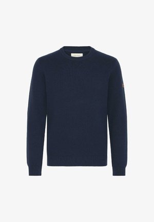 Tums zilas krūštura džemperis, kas izgatavots no mīkstas auduma. Aprīkots ar garām piedurknēm, ribotām aprocēm un apakšmalu, ar nelielu brūngu akcentu uz pleca.