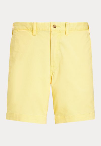 Žlté bavlnené šortky s gombíkovým zapínaním, jedným predným vreckom a natáčacím lemom. Hladká textúra, rovný strih a ležérny dizajn.