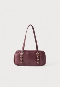 Maroon leather handbag with two long straps, gold hardware accents, rectangular shape, and smooth texture. Features double buckle detail on straps.