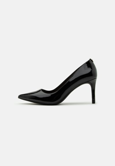 Pump à talon haut en cuir verni noir avec un bout pointu et une silhouette épurée, présentant une texture lisse et un design minimaliste.