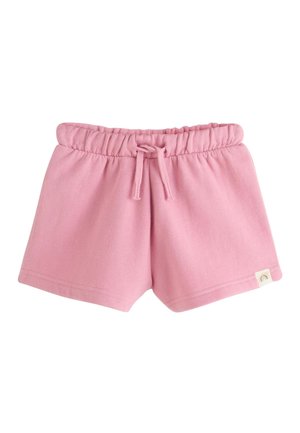 Różowe spodenki dla malucha z elastycznym pasem i troczkiem, wykonane z miękkiej tkaniny, z małą tęczową metką na dole.