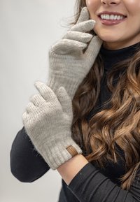 Light gray knitted gloves with a ribbed cuff. Fabric appears soft with a subtle texture. A small leather logo patch is visible on the wrist.