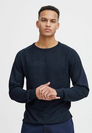 Dunkelblauer Langarmpullover aus strukturiertem Material, mit Rundhalsausschnitt und gerippten Bündchen. Einfaches Design ohne Muster oder Akzente.