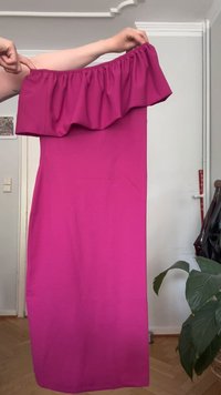 Vestido fúcsia com decote ombro a ombro, gola com babados, textura suave e silhueta justa, pendurado contra um fundo neutro.