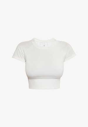 Fehér, rövidített póló sima, rugalmas anyagból. Rövid raklankákkal és kerek nyakkivágással rendelkezik. Egyszerű, egyszínű dizájn.