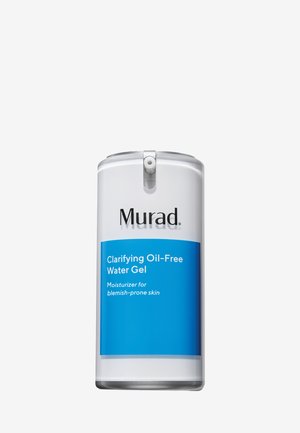 Murad Clarifying Gel Hydratant Sans Huile dans un contenant cylindrique transparent. L'étiquette présente un texte blanc sur fond bleu, mettant en avant les détails du produit.