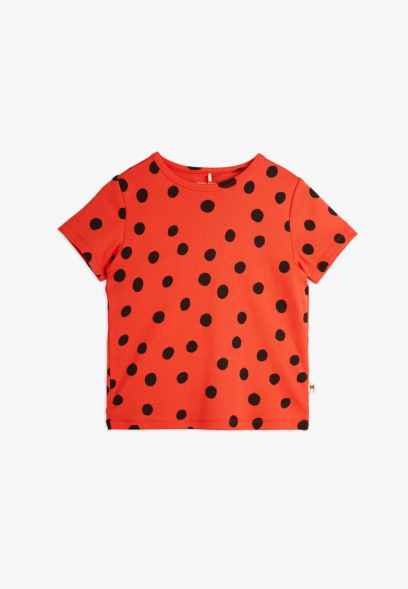 Red short-sleeve T-shirt featuring a black polka dot pattern. Round neckline with a smooth texture. Lightweight, casual design.