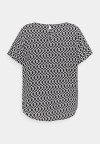Blouse noire et blanche à manches courtes avec motif géométrique oval répétitif et petite fermeture en trou de serrure au niveau de l'encolure arrière.