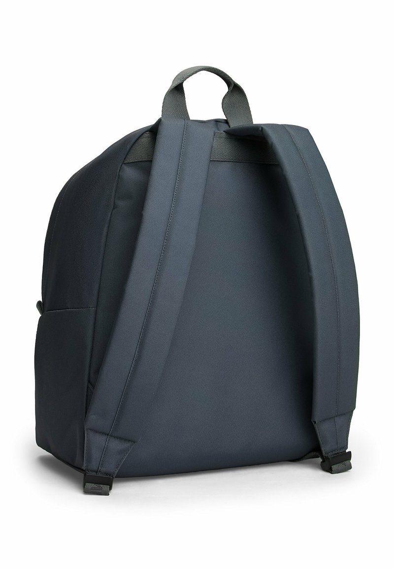 Dark gray backpack with a textured finish, padded shoulder straps, and a top handle. Features a minimalistic design without visible logos.