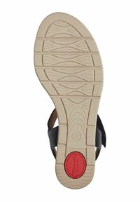 Sandalo nero con suola in gomma beige testurizzata, dotato di un accento rosso e indicazione di taglia 37. La parte superiore ha un design minimalista per il massimo comfort.