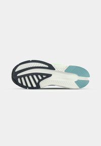 Shoe outsole featuring a black rubber heel, white midsole, and turquoise accents; textured patterns for grip and stability.