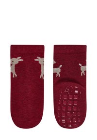 Red socks featuring a beige goat pattern, with a textured non-slip grip sole. Soft material and ankle-length design for comfort and stability.