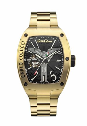 Gold-toned metal watch with a rectangular case, black embossed dial, white hour markers, and visible mechanical movement details.