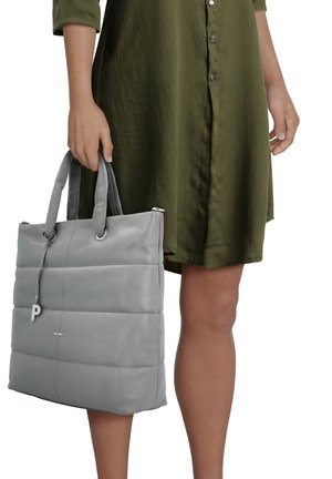 Gray leather tote bag with padded design, smooth texture, two handles, and a silver accent featuring a 'P' logo, held by a person.