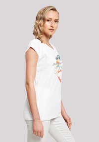White cotton T-shirt featuring a graphic print of a superhero. Short sleeves and a relaxed fit. Smooth texture, casual design.