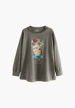 Oliivroheline pika varrukaga särk, millel on lilleportree trükk ja Frida Kahlo tsitaat. Pehme kangas, mugav lõige ja ümar kaelus.