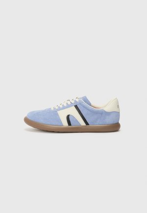 Blue suede sneaker with cream and black accents, round toe, and white laces. Rubber sole with a textured grip. Simple and sleek design.