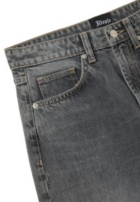Jeans in denim grigio con una finitura sbiadita, caratterizzati da cuciture in vista, una tasca frontale e un'etichetta con il marchio sulla vita. Chiusura con bottone inclusa.