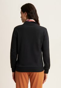 Freddy CON DETTAGLI - Sudadera con cremallera - black zebraanimaliermulticolor