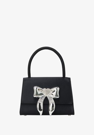 Black handbag with a structured design, featuring a glossy silver bow with a rhinestone heart centerpiece and a short, rounded handle.