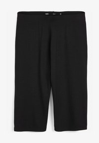 Leggings negros de algodón elástico, con un diseño simple que incluye una cinturilla elástica y un corte hasta la rodilla. Sin patrones ni acentos.