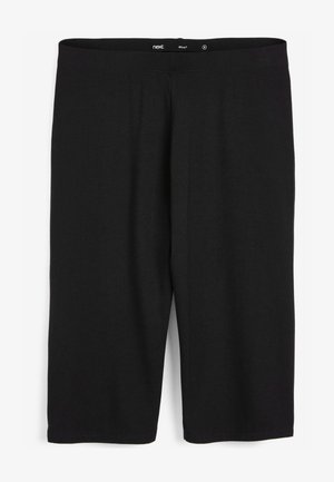 Crne tajice od rastezljivog pamuka sa jednostavnim dizajnom, elastičnim pojasom i dužinom do koljena. Bez uzoraka ili ukrasa.