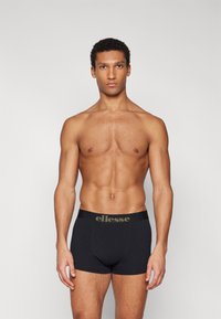Black Boxer Briefs made of cotton, featuring a broad waistband with the "ellesse" logo in olive green. Smooth texture and fitted design.