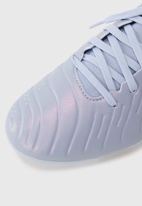 Light blue synthetic shoe with textured wave pattern and rounded toe. Features lace-up closure and smooth finish.