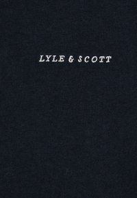 Tissu de vêtement bleu marine avec une texture lisse, présentant le texte brodé blanc "LYLE & SCOTT" centré sur la zone du torse.