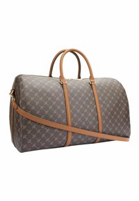 Ruskea kuvioitu duffel-laukku, jossa on vaaleanruskeat nahkakä handles ja hihna. Varustettu vetoketjulla ja huomaamattomalla logopainatuksella sivussa.