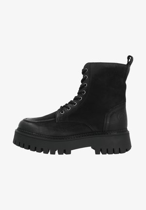 Botte de combat en cuir noir à lacets avec semelle épaisse et crantée, et languette d'extraction à l'arrière.