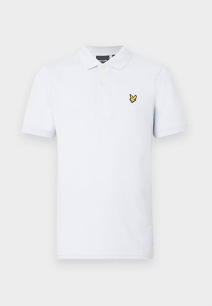 Valge puuvillane polo särk. Omab krae, kolme nuppu ja kollast tikandit vasakul rinnal. Lühikesed varrukad.