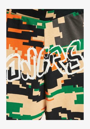 Multicolored joggers feature a pixelated camouflage pattern in green, orange, black, and beige, with the word "CONGRATS" in white lettering.