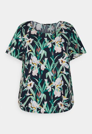 Marineblaue Bluse mit kurzen Ärmeln, grünem Blatt- und weiß-pinkem Blumenmuster, rundem Ausschnitt und lockerem Schnitt.