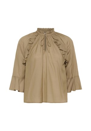 Blouse beige à manches longues avec détails volantés sur les épaules, un col montant froncé avec lien à nouer, et des poignets évasés.