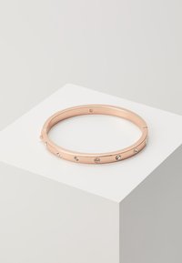 Rose gold bangle bracelet with a smooth metallic finish and evenly spaced clear rhinestones along the outer edge. Round shape, slim profile.
