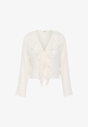 Blusa blanca corta hecha de tejido texturizado con un cuello con volantes y un lazo en la parte frontal, que cuenta con mangas largas que se ensanchan ligeramente en los puños.