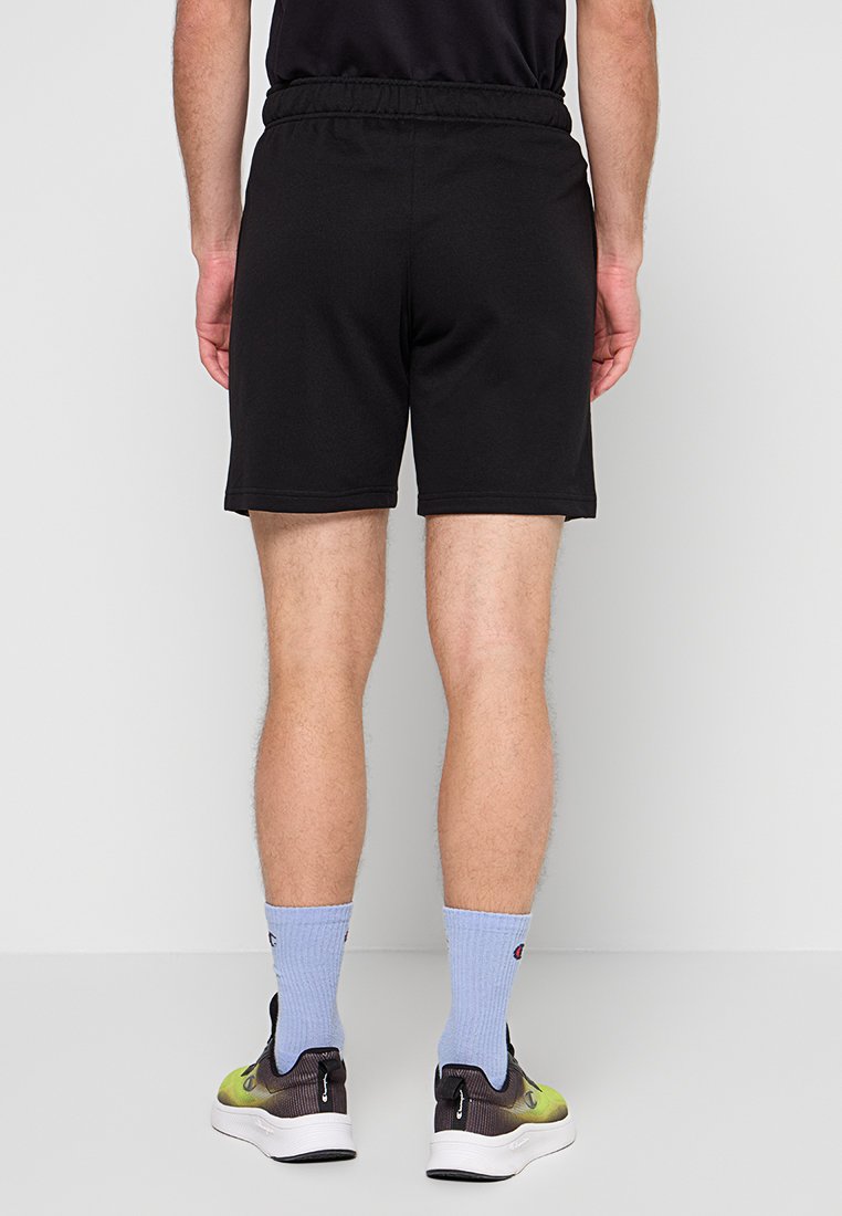 Pantalones cortos atléticos negros en una tela ligera con cintura elástica. Textura suave y longitud por encima de la rodilla. Diseño simple.