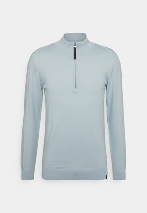 Pullover azzurro chiaro con colletto alto e zip a metà. Tessuto morbido, maniche lunghe e dettagli a coste ai polsini e all'orlo.