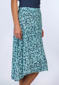 Floral skirt in dark blue with a pattern of light blue flowers. Smooth fabric, flowy design, and a slightly flared hem.