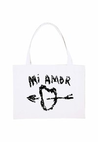 Borsa a spalla in tela, bianca con scritte nere "Mi Amor", caratterizzata da un design con cuore e freccia. Manici robusti, texture minimale.