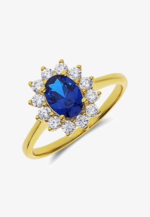 Gold ring featuring an oval blue gemstone surrounded by a cluster of round clear stones, showcasing a polished finish and smooth band.