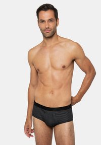 Zwarte boxershorts met strepen en een zwarte elastische tailleband, gemaakt van zacht materiaal, met een aansluitend ontwerp en een gladde textuur.