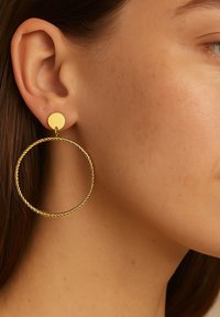 Gold hoop earrings feature a twisted design with a small round stud attachment. The finish is shiny, accentuating the circular shape.