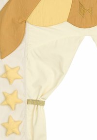 Cotton fabric in beige and cream tones features a star pattern in yellow, with decorative gold accents and a textured light brown section.