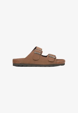 Brown suede slide sandal with two adjustable buckles, cork footbed, and black rubber sole. Simple design with no patterns or excessive detailing.